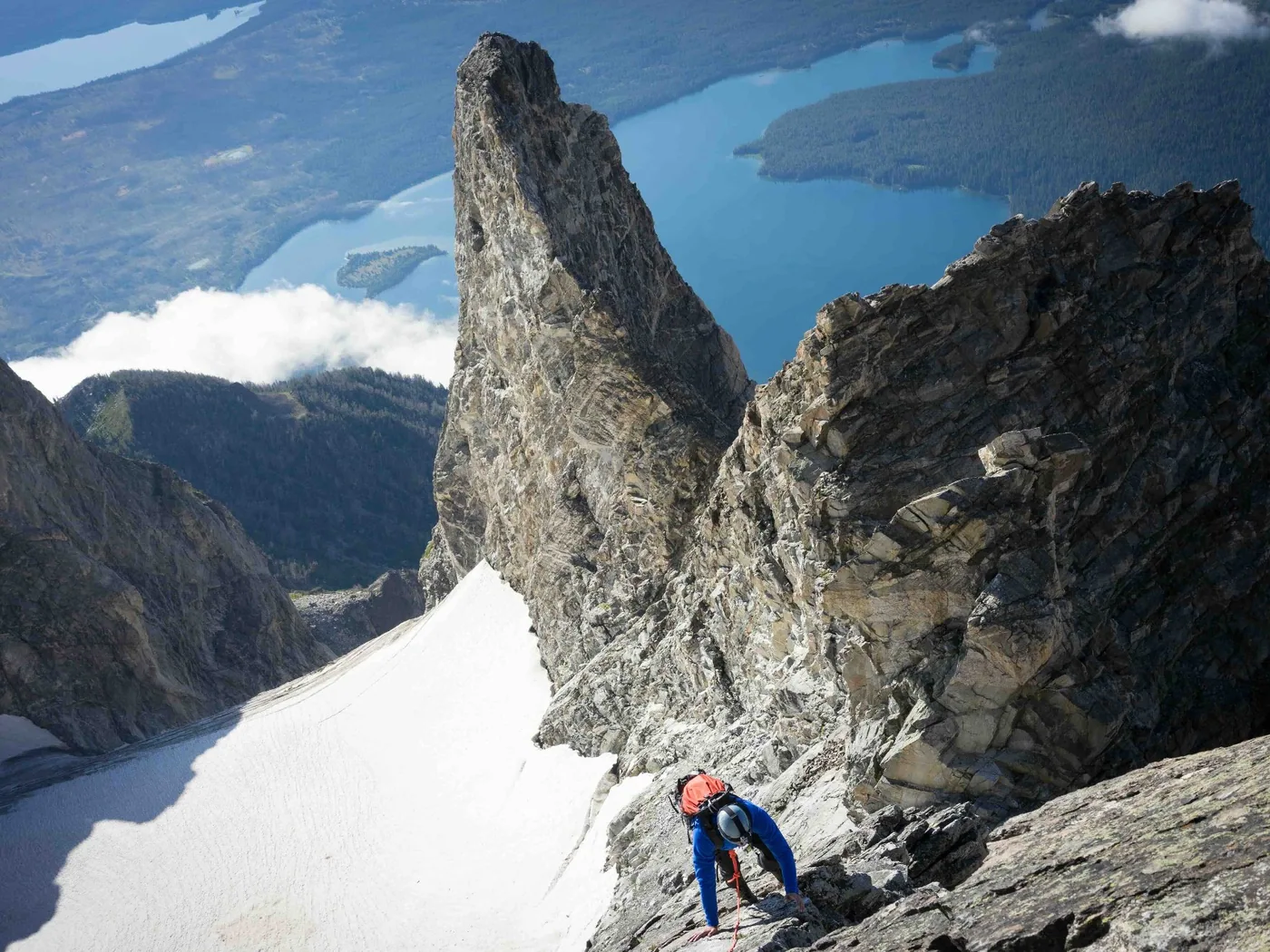 Dr. Taylor Workman climbing a rocky ridge high in the mountains